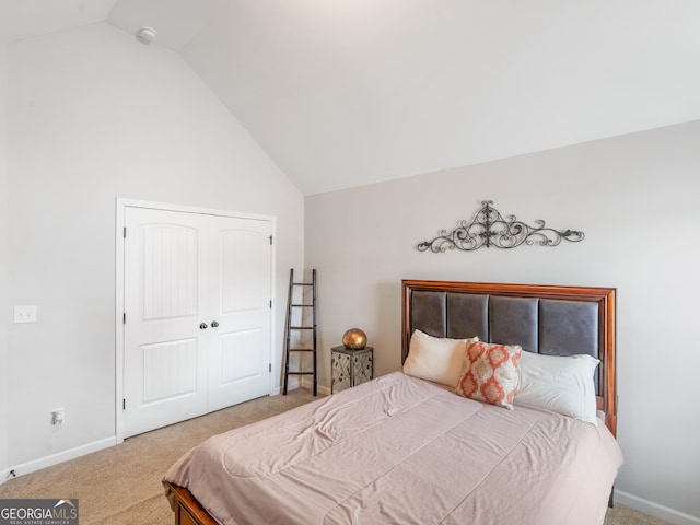 carpeted bedroom with baseboards, lofted ceiling, and a closet