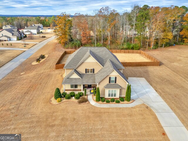 exterior space featuring driveway and roof with shingles