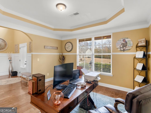 home office with visible vents, crown molding, wood finished floors, baseboards, and a tray ceiling