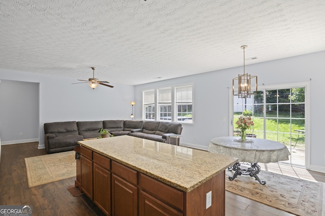 35 Timber Ln, Newnan, GA 30265 - kitchen featuring a chandelier, a textured ceiling, dark wood-type flooring, a ceiling fan, and hanging light fixtures