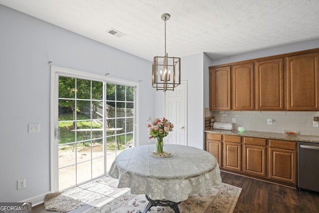 35 Timber Ln, Newnan, GA 30265 - kitchen featuring dishwasher, a chandelier, dark wood finished floors, brown cabinets, and decorative backsplash