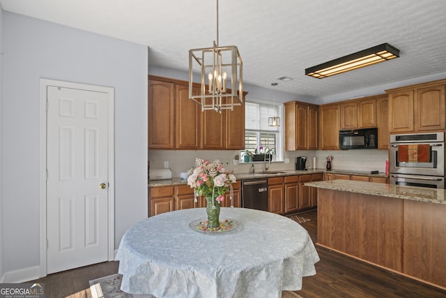 35 Timber Ln, Newnan, GA 30265 - kitchen featuring black appliances, brown cabinets, a chandelier, and tasteful backsplash