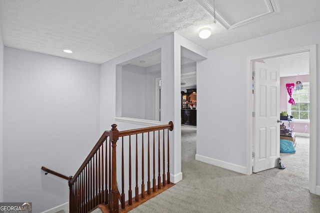 35 Timber Ln, Newnan, GA 30265 - hall with an upstairs landing, carpet flooring, and a textured ceiling