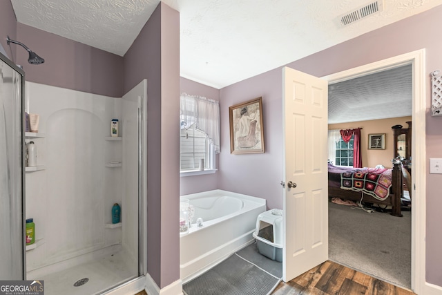 35 Timber Ln, Newnan, GA 30265 - bathroom featuring connected bathroom, a stall shower, a bath, and wood finished floors