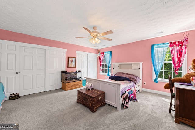 35 Timber Ln, Newnan, GA 30265 - bedroom with carpet, a textured ceiling, multiple closets, and ceiling fan