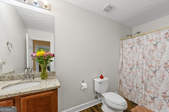35 Timber Ln, Newnan, GA 30265 - bathroom with wood finished floors, vanity, curtained shower, and a textured ceiling