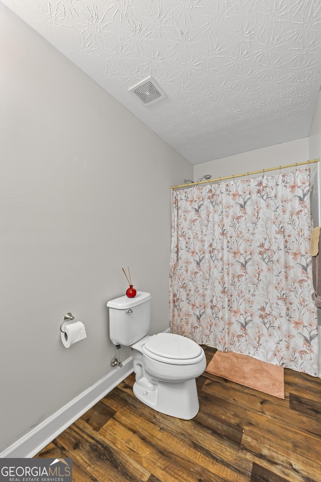 35 Timber Ln, Newnan, GA 30265 - bathroom featuring wood finished floors, curtained shower, and a textured ceiling