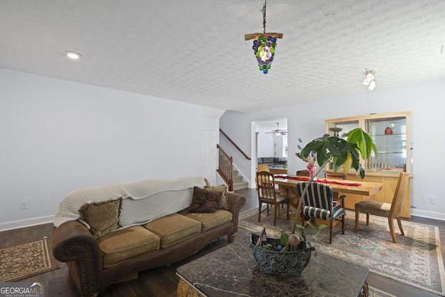 35 Timber Ln, Newnan, GA 30265 - living room with stairs, dark wood-type flooring, a ceiling fan, and a textured ceiling