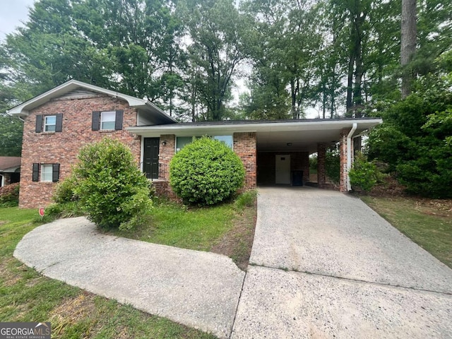 1263 Shoreham Dr, Atlanta, GA 30349 - split level home with an attached carport, brick siding, and driveway