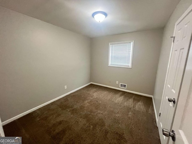 1263 Shoreham Dr, Atlanta, GA 30349 - unfurnished bedroom with visible vents, baseboards, and dark colored carpet