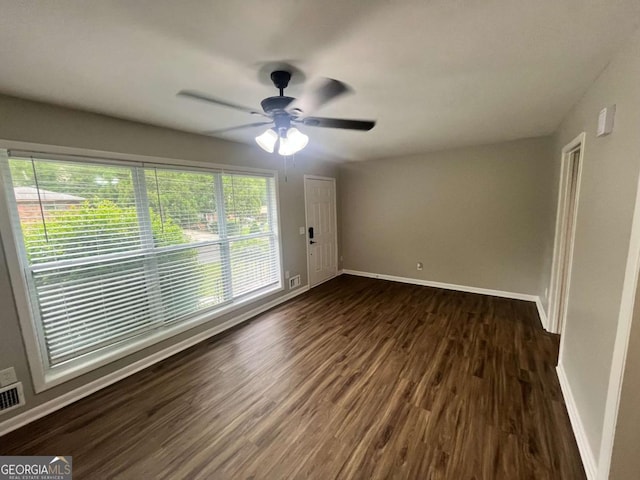 1263 Shoreham Dr, Atlanta, GA 30349 - spare room featuring baseboards, a ceiling fan, visible vents, and dark wood finished floors
