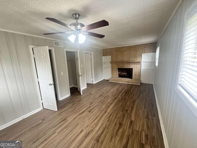 1263 Shoreham Dr, Atlanta, GA 30349 - unfurnished living room with a brick fireplace, a ceiling fan, visible vents, and wood finished floors