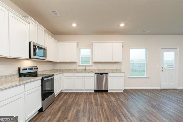 244 Oliver Dr, Locust Grove, GA 30248 - kitchen featuring white cabinets, a sink, stainless steel appliances, dark wood-type flooring, and visible vents