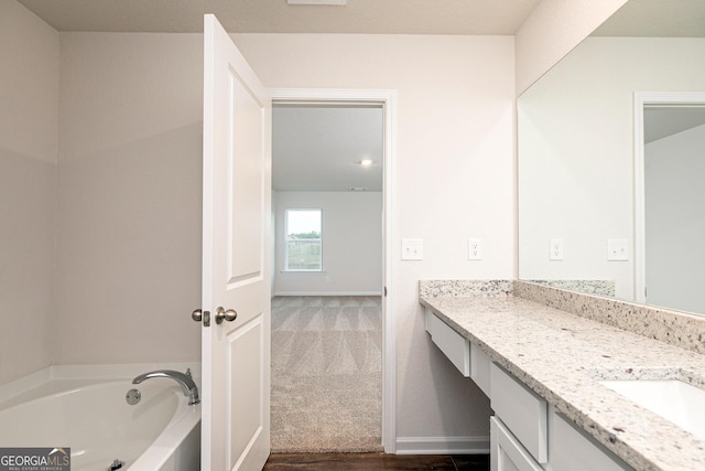 244 Oliver Dr, Locust Grove, GA 30248 - full bathroom with vanity, baseboards, and a garden tub