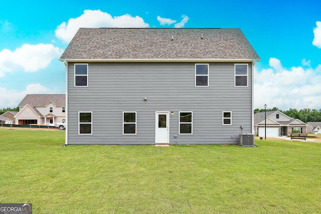244 Oliver Dr, Locust Grove, GA 30248 - rear view of property featuring a lawn and central AC