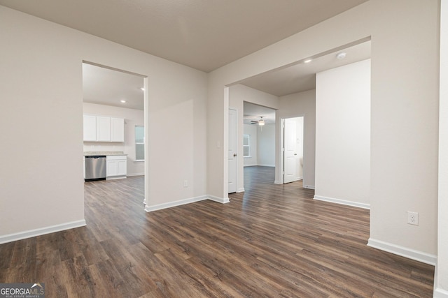 244 Oliver Dr, Locust Grove, GA 30248 - unfurnished living room featuring baseboards, ceiling fan, and dark wood-style flooring