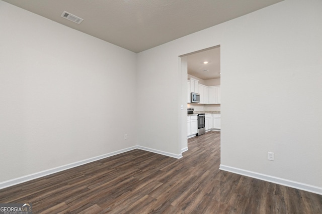 244 Oliver Dr, Locust Grove, GA 30248 - empty room with visible vents, recessed lighting, dark wood-style flooring, and baseboards