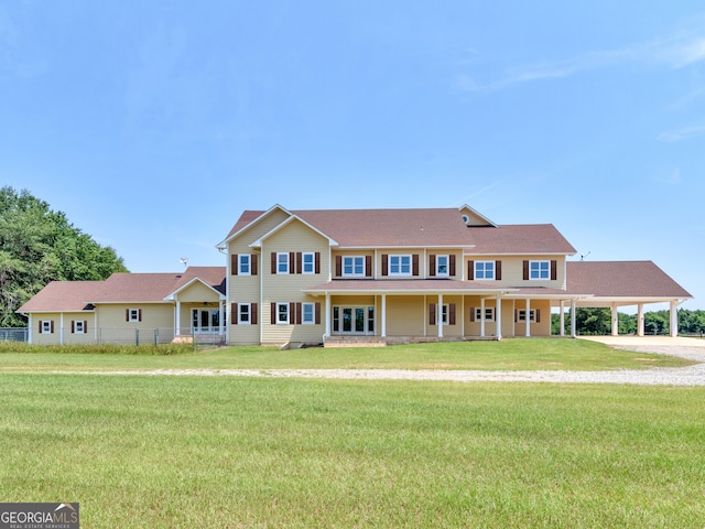 view of front of house with a front lawn, fence, driveway, and a carport