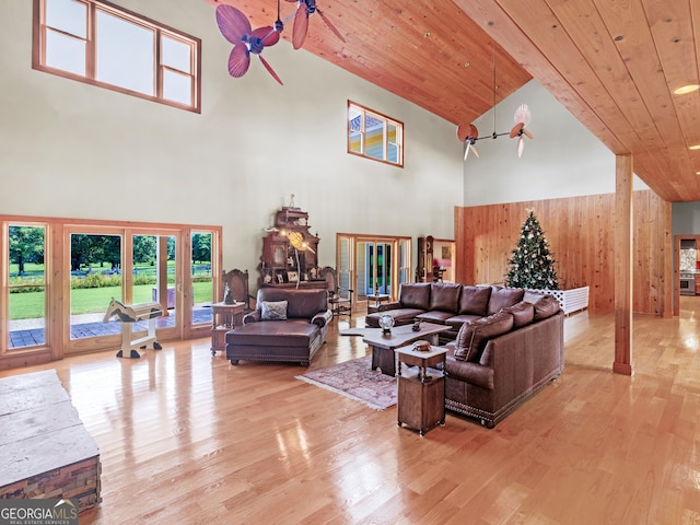 living area with light wood-style floors, wood ceiling, and high vaulted ceiling