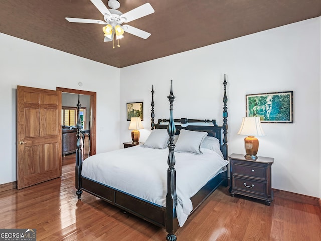 bedroom with baseboards, a ceiling fan, and wood finished floors