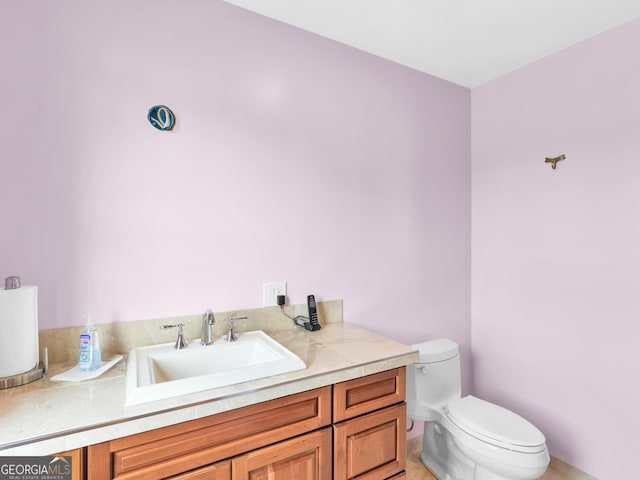 bathroom with vanity, tile patterned flooring, and toilet