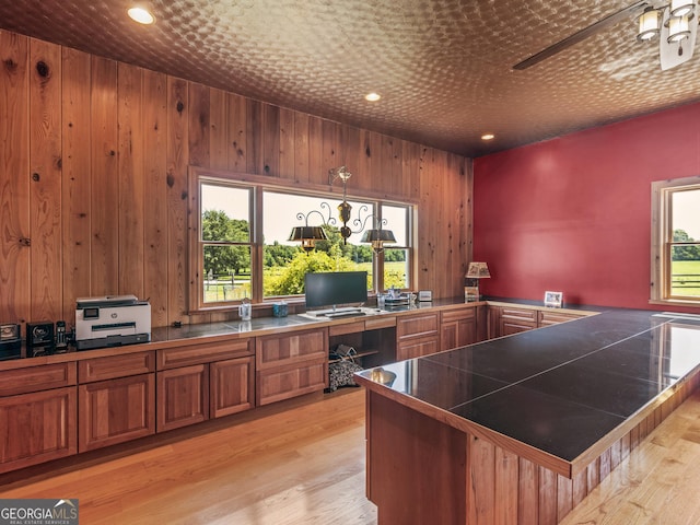 office space with light wood-style floors, wood walls, and recessed lighting