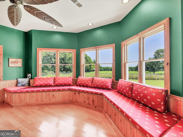 interior space with ceiling fan, visible vents, a wealth of natural light, and wood finished floors