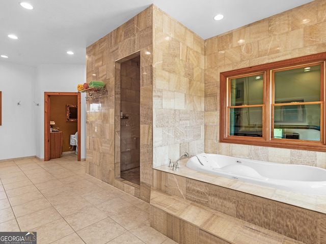 bathroom with tile patterned flooring, recessed lighting, a bath, and a tile shower