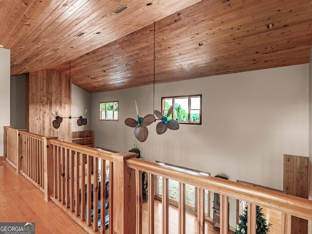 hall featuring wood ceiling, lofted ceiling, and wood finished floors