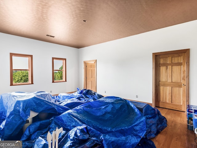 bedroom with wood finished floors and visible vents