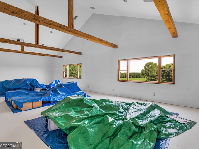 bedroom with high vaulted ceiling and beam ceiling