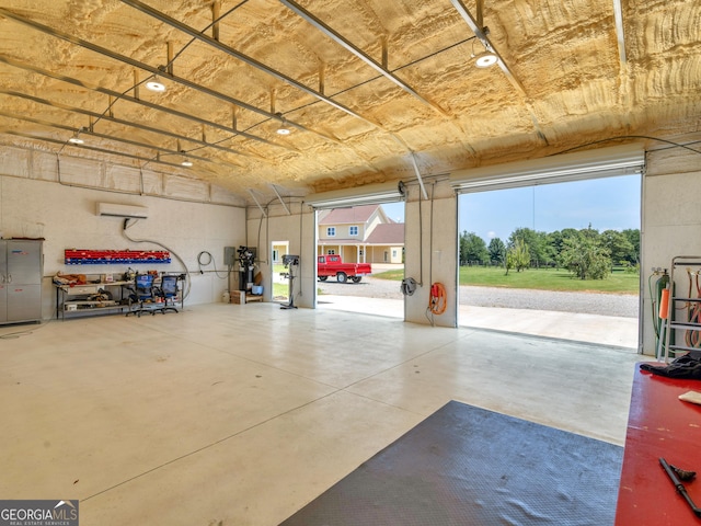 garage featuring a wall mounted air conditioner