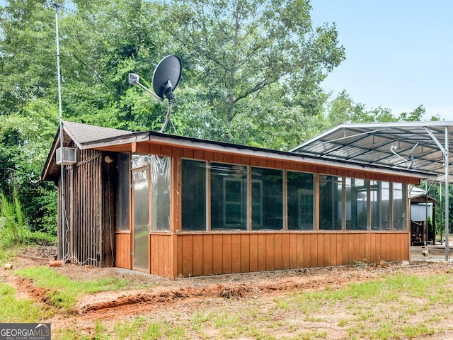 view of property exterior featuring a sunroom