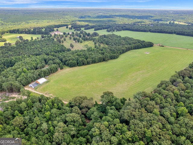 bird's eye view with a wooded view