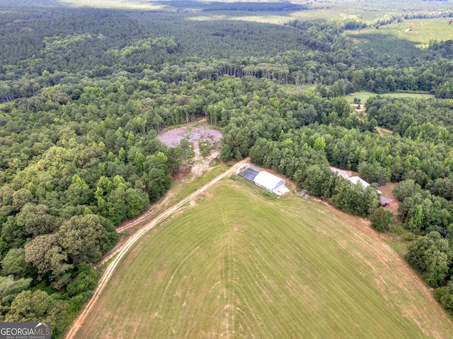 birds eye view of property featuring a forest view