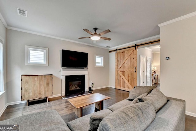6468 Pierless Ave, Sugar Hill, GA 30518 - living area featuring visible vents, a barn door, a ceiling fan, and a wealth of natural light