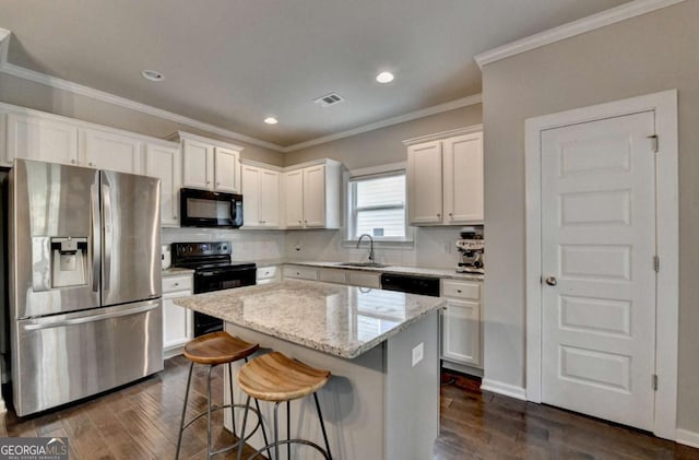 6468 Pierless Ave, Sugar Hill, GA 30518 - kitchen with a sink, a center island, black appliances, and dark wood finished floors