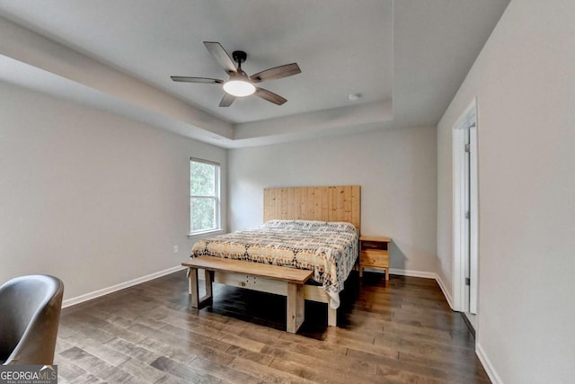 6468 Pierless Ave, Sugar Hill, GA 30518 - bedroom featuring a raised ceiling, baseboards, a ceiling fan, and wood finished floors