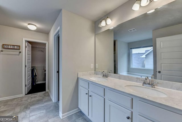 6468 Pierless Ave, Sugar Hill, GA 30518 - bathroom with visible vents, a sink, double vanity, and a spacious closet