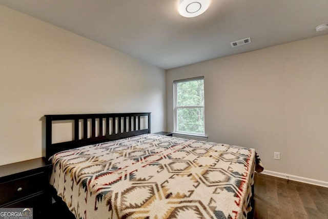 6468 Pierless Ave, Sugar Hill, GA 30518 - bedroom with visible vents, dark wood-style flooring, and baseboards