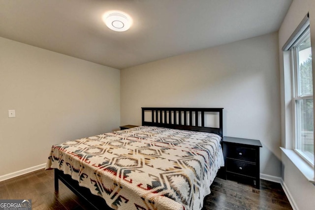 6468 Pierless Ave, Sugar Hill, GA 30518 - bedroom featuring baseboards and dark wood-type flooring