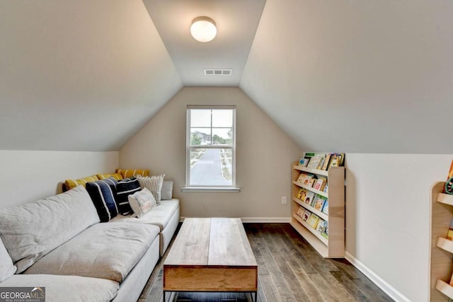 6468 Pierless Ave, Sugar Hill, GA 30518 - living area featuring baseboards, dark wood-style floors, vaulted ceiling, and visible vents