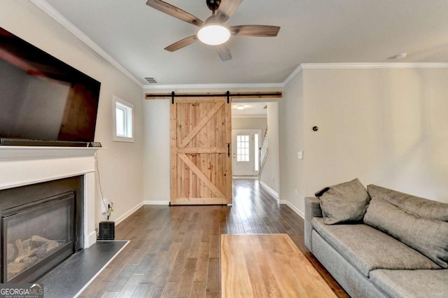 6468 Pierless Ave, Sugar Hill, GA 30518 - living room with ceiling fan, a barn door, ornamental molding, and plenty of natural light