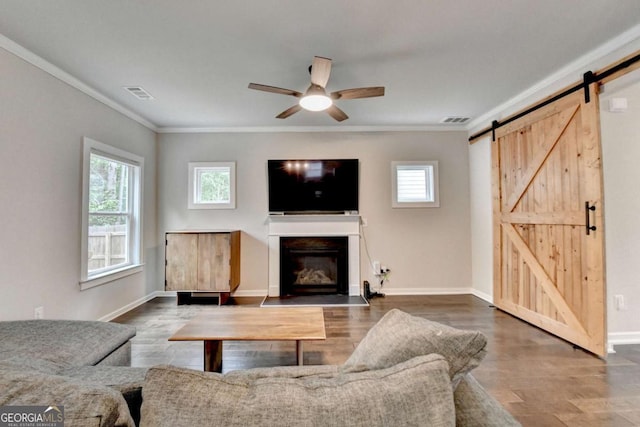 6468 Pierless Ave, Sugar Hill, GA 30518 - living room with ceiling fan, ornamental molding, a barn door, and visible vents
