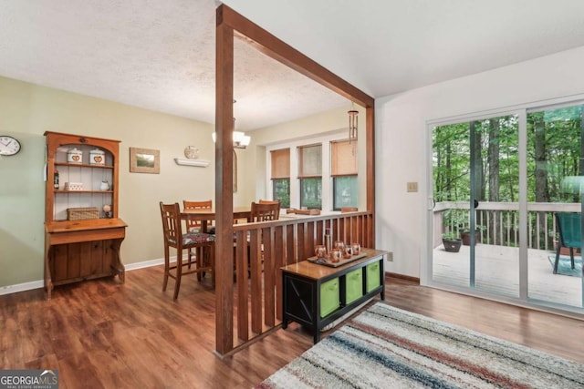 3679 Regent Dr NW, Kennesaw, GA 30144 - dining area with a textured ceiling, baseboards, an inviting chandelier, and wood finished floors