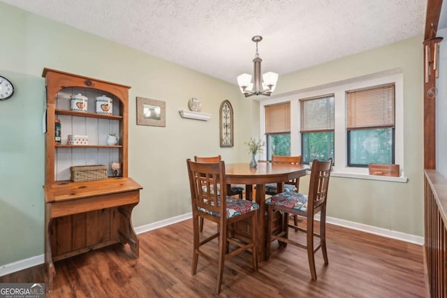 3679 Regent Dr NW, Kennesaw, GA 30144 - dining space with a textured ceiling, baseboards, an inviting chandelier, and wood finished floors