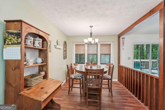 3679 Regent Dr NW, Kennesaw, GA 30144 - dining room featuring an inviting chandelier, a textured ceiling, and wood finished floors
