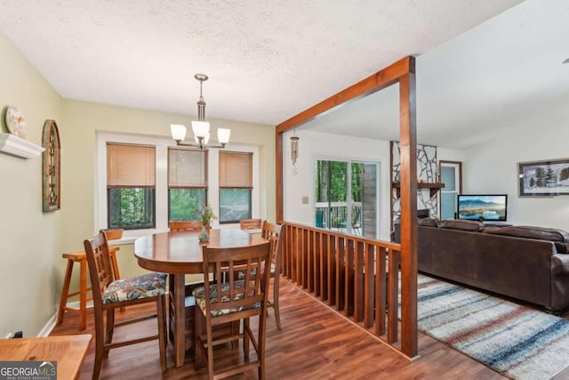 3679 Regent Dr NW, Kennesaw, GA 30144 - dining area with a textured ceiling, a notable chandelier, and wood finished floors
