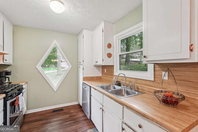 3679 Regent Dr NW, Kennesaw, GA 30144 - kitchen featuring dark wood-style flooring, appliances with stainless steel finishes, a sink, light countertops, and white cabinets