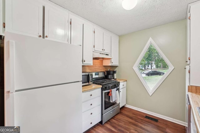 3679 Regent Dr NW, Kennesaw, GA 30144 - kitchen featuring visible vents, under cabinet range hood, stainless steel appliances, white cabinetry, and dark wood-type flooring
